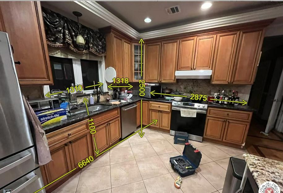 The original kitchen before renovation, with dark cherry-wood cabinets and granite counters