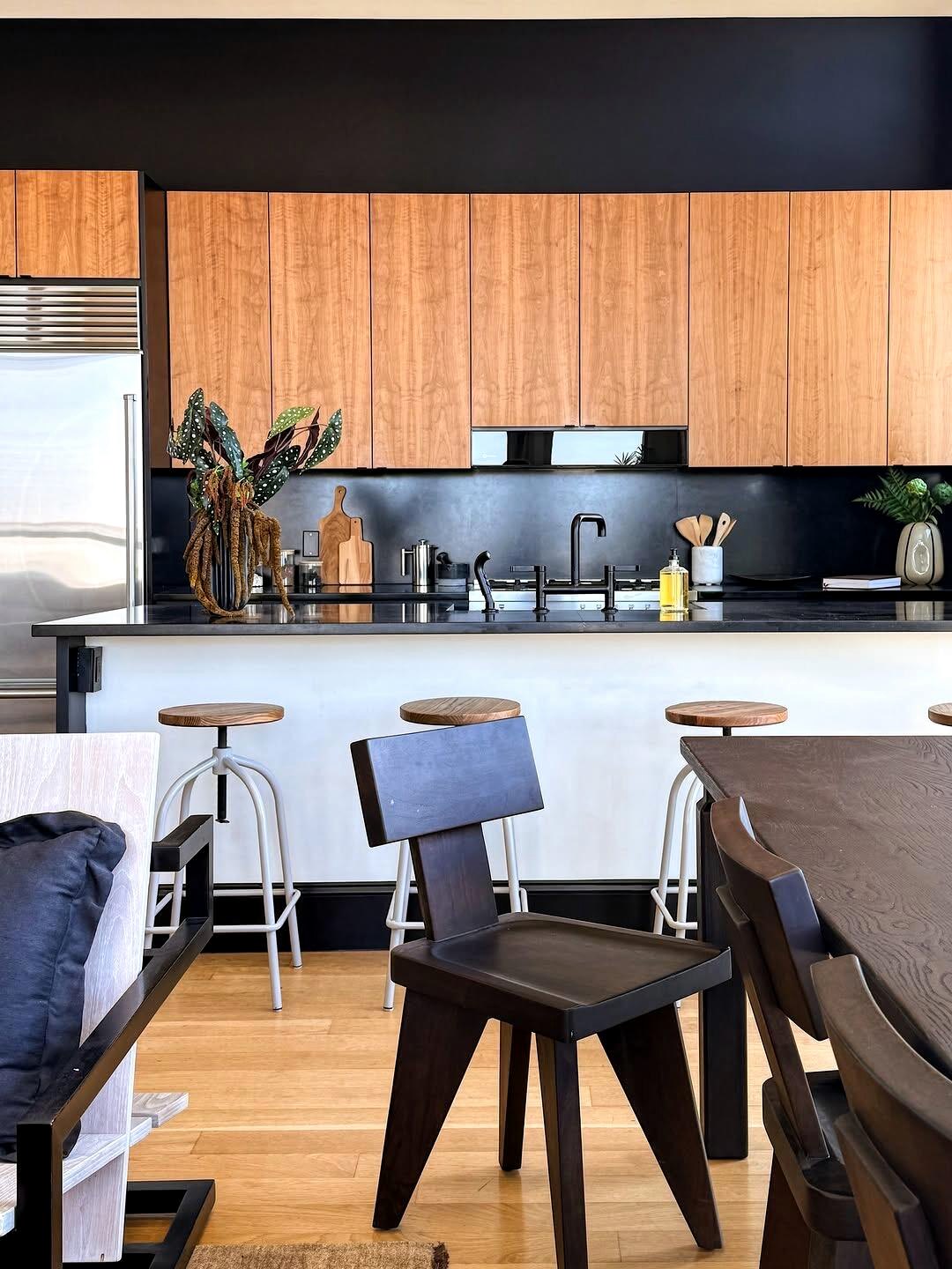 Kitchen detail with black counter and wood cabinetry