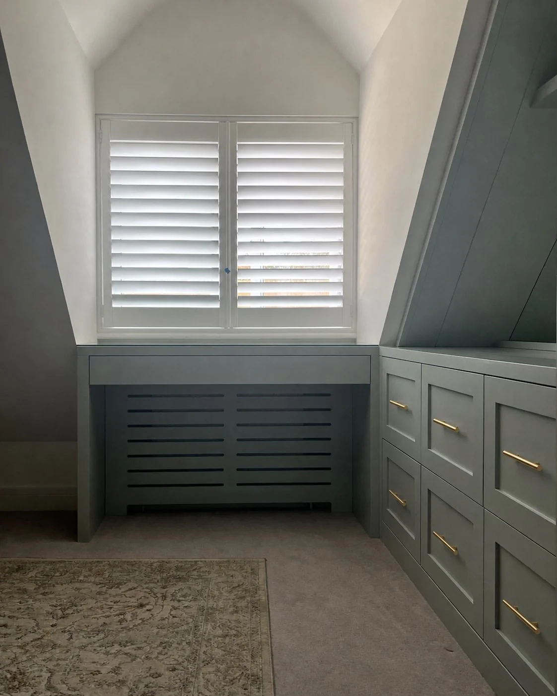 Sage Collection fitted wardrobes beneath a sloped ceiling