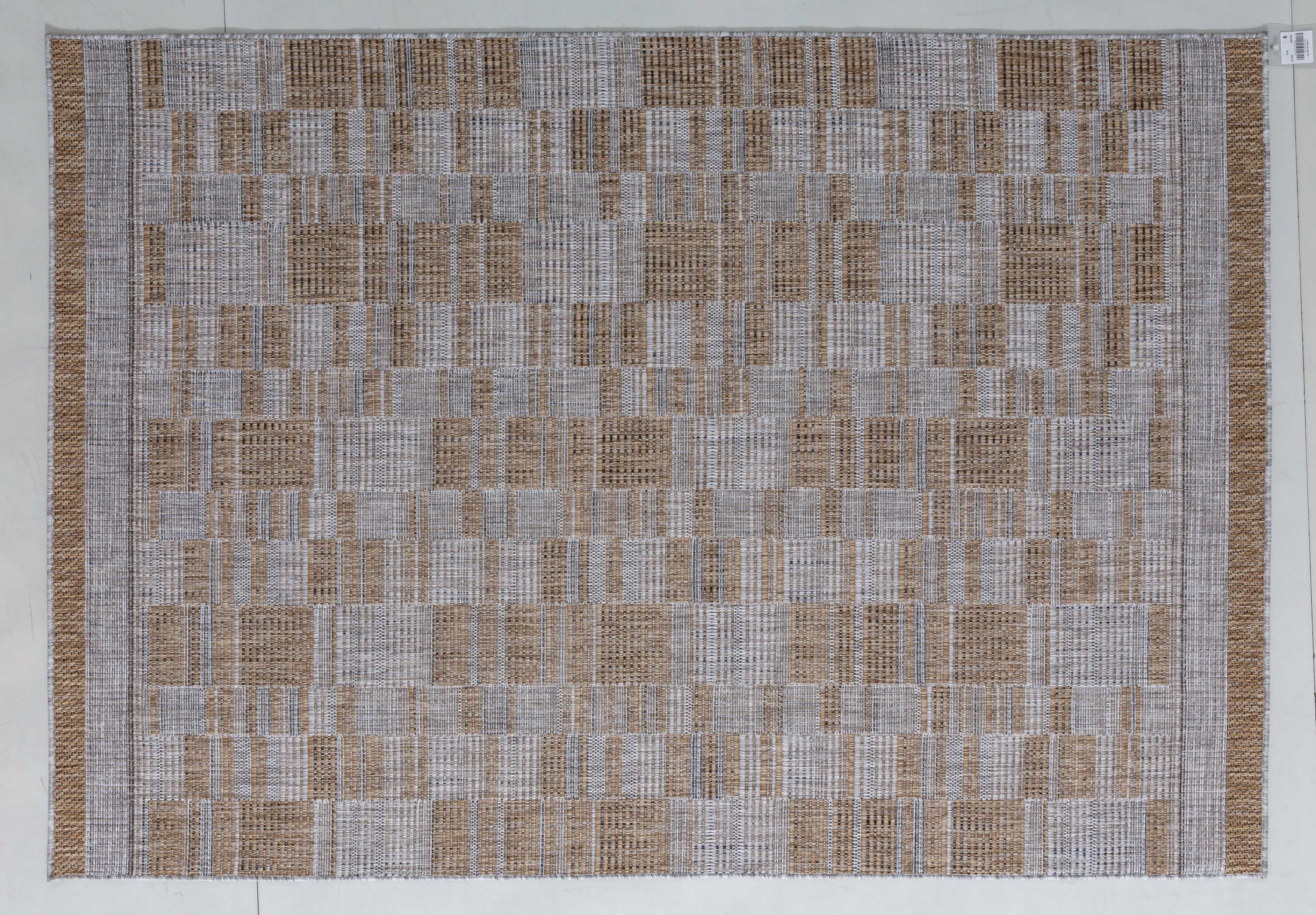 Palm Cairn Area Rug in a finished interior.