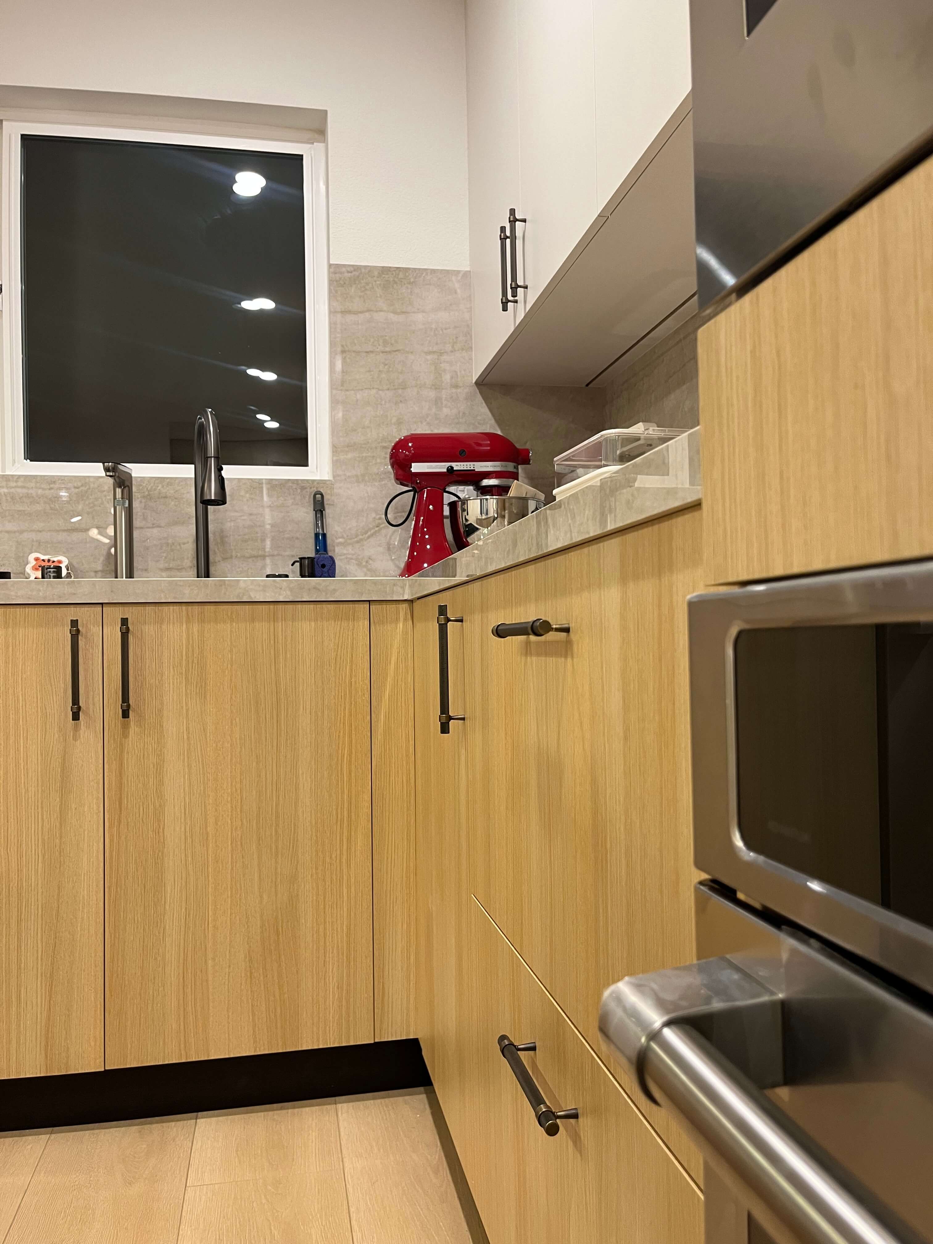 Sink run under the window with the oven stack on the right