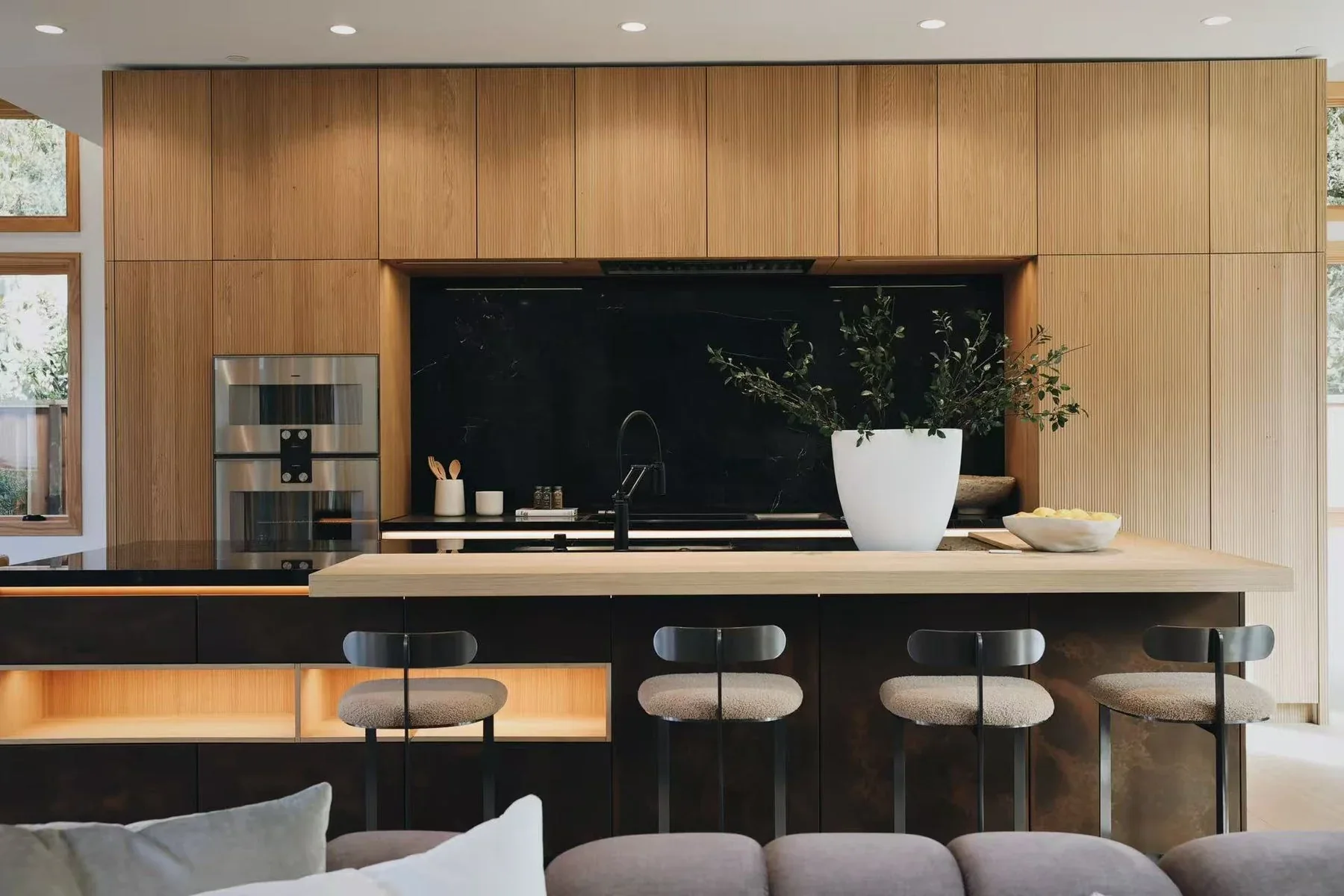 Custom wood cabinetry kitchen with integrated appliances and island seating