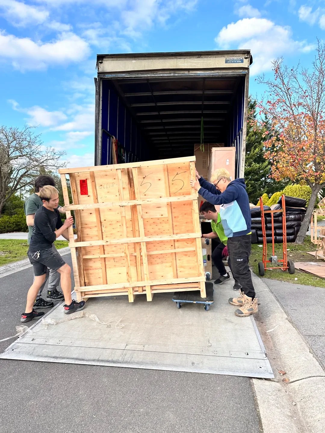 Crated furniture being loaded into a truck