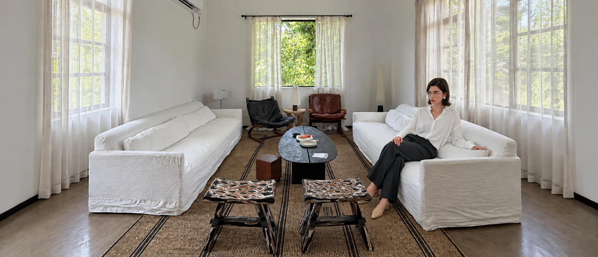 Interior designer seated in a light-filled living room