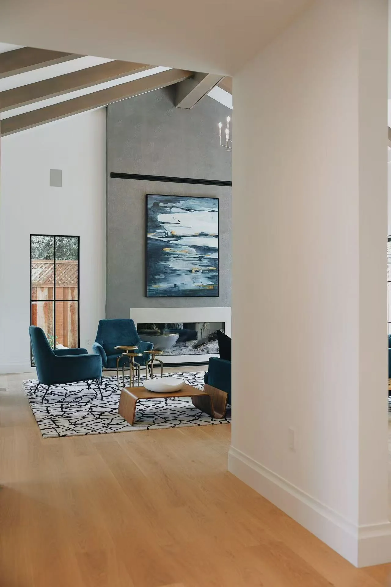 View from hallway into the living room and fireplace feature