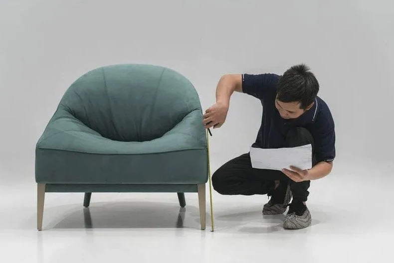 Furniture inspector measuring a chair before shipment