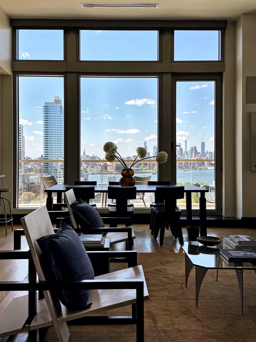 Living room with black framed windows and city view