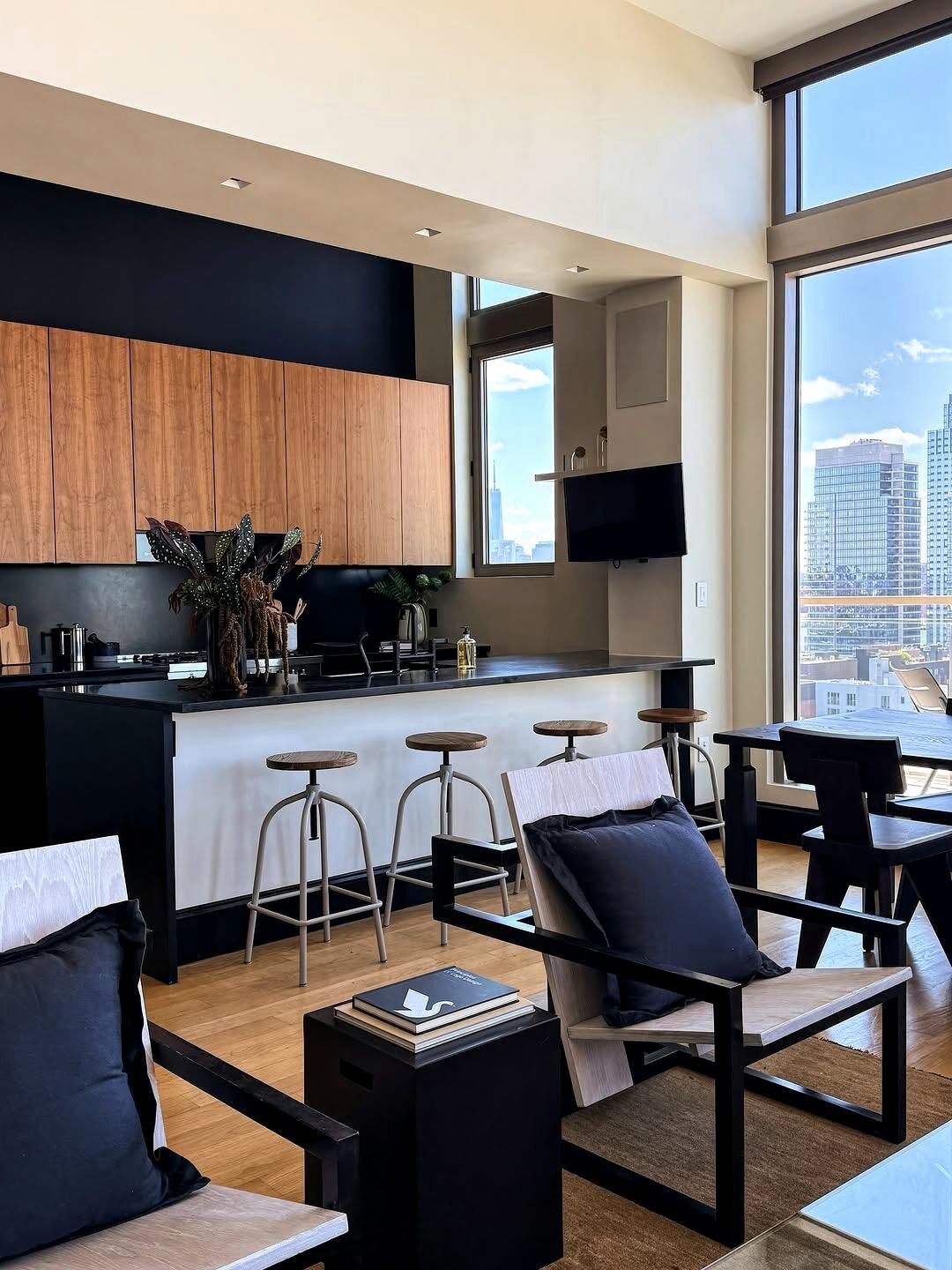 Open kitchen with warm wood cabinets and black accents