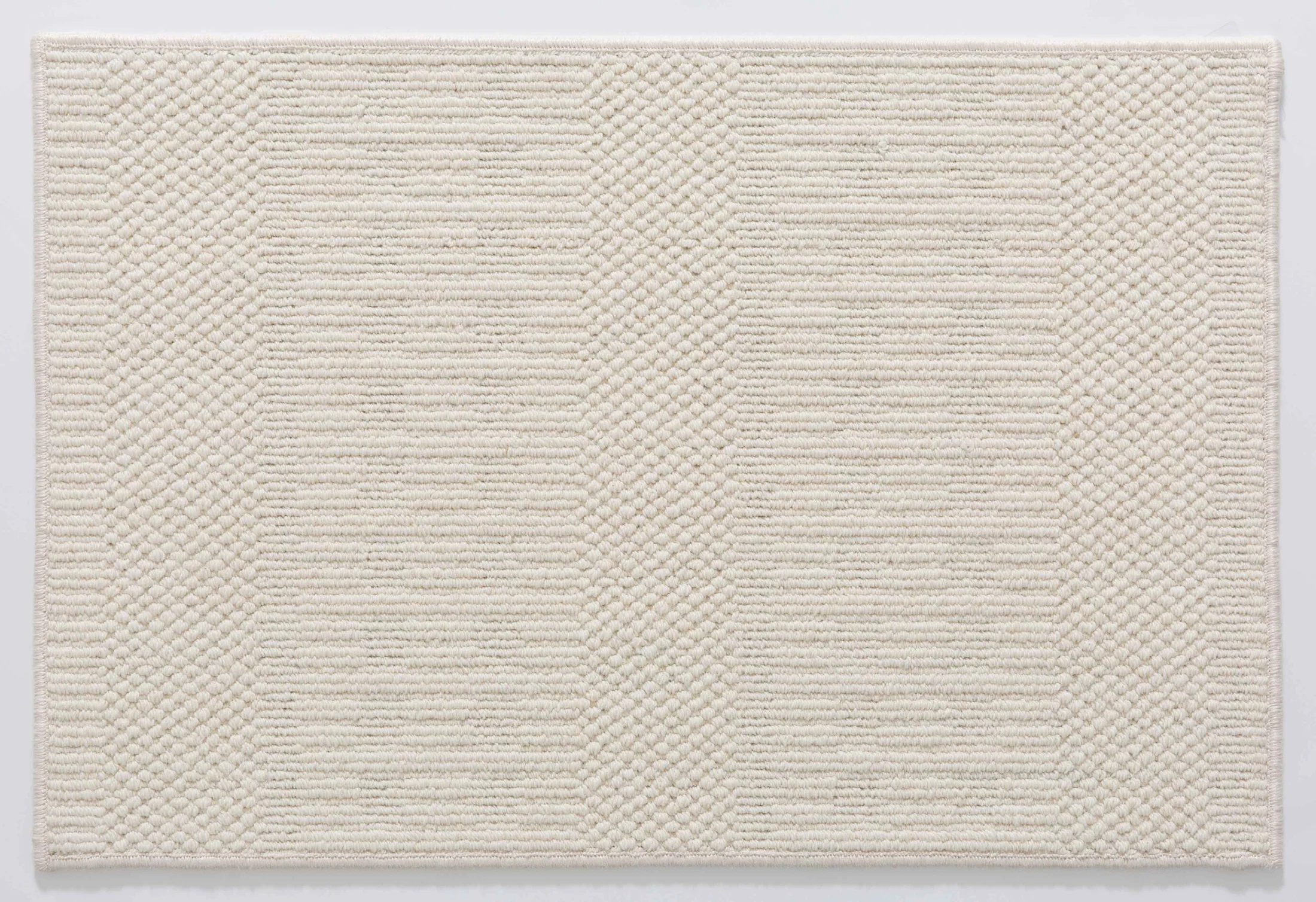 Wheat Arc Area Rug in a finished interior.