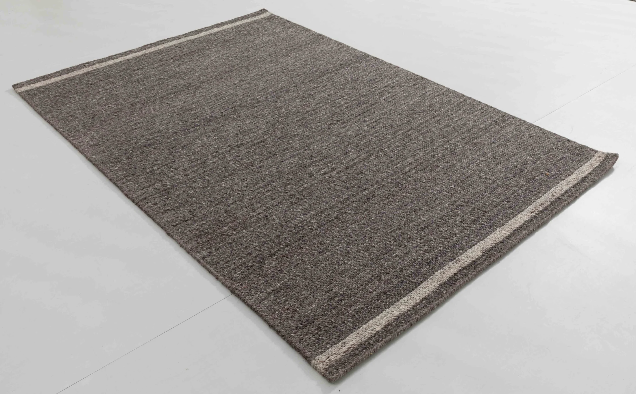 Bus Arc Area Rug in a finished interior.
