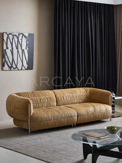 Willow Haven Sofa - golden brown sofa with gathered upholstery and metal supports in a living room